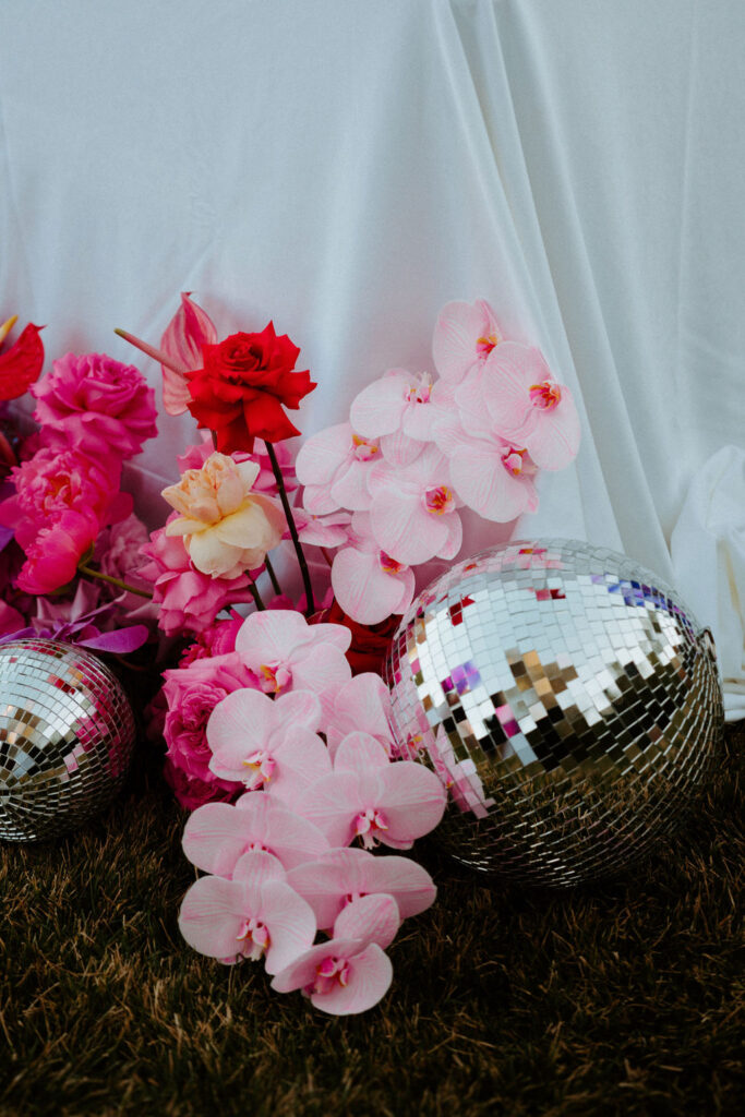Pink orchids and disco ball for wedding decor 