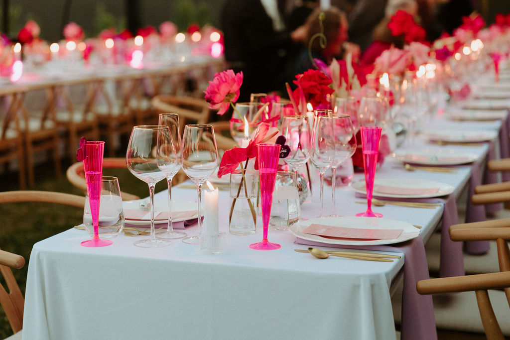 Pink champagne flutes on wedding reception tables 