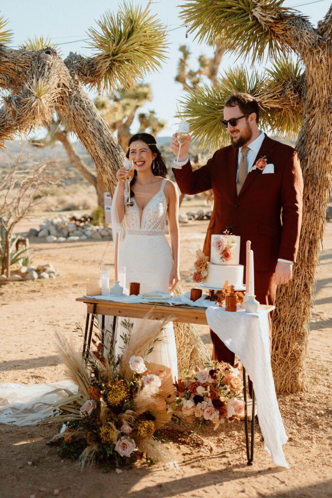 Couple doing champagne toast. Intimate Elopement at Rimrock Ranch in Joshua Tree California