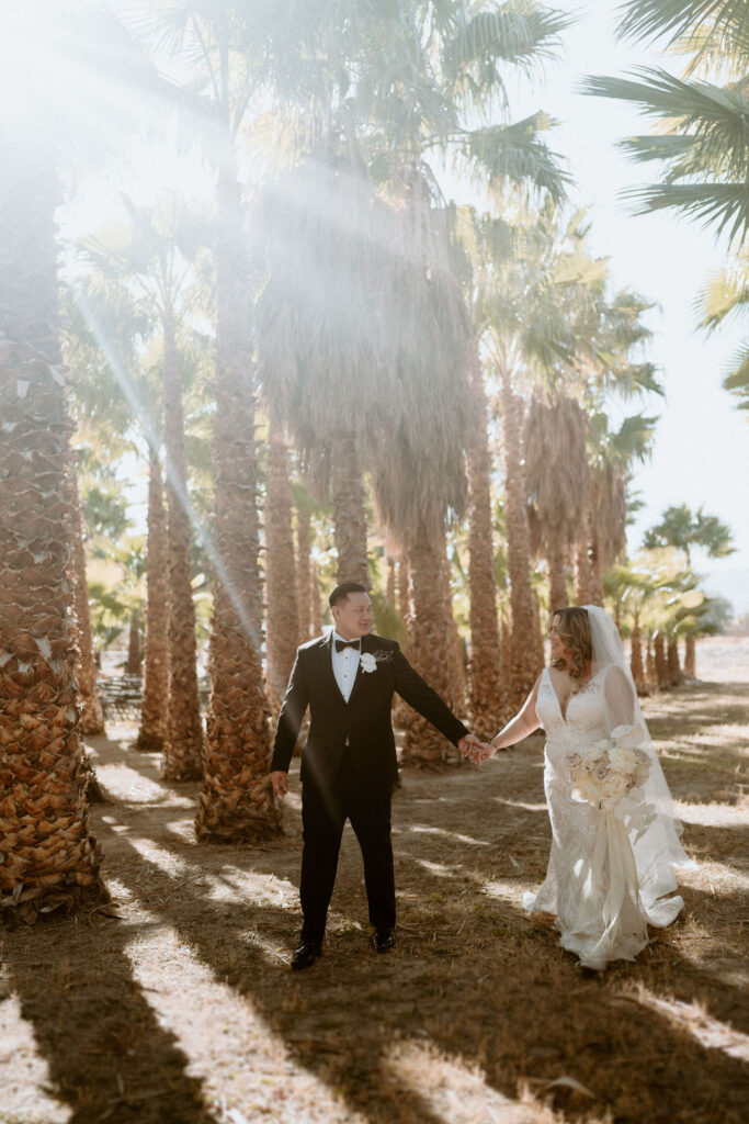 Bride and Groom walking though palm trees