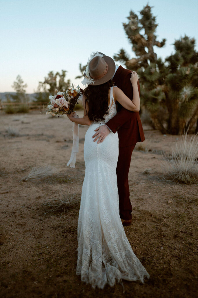 Couple kissing in desert after eloping 