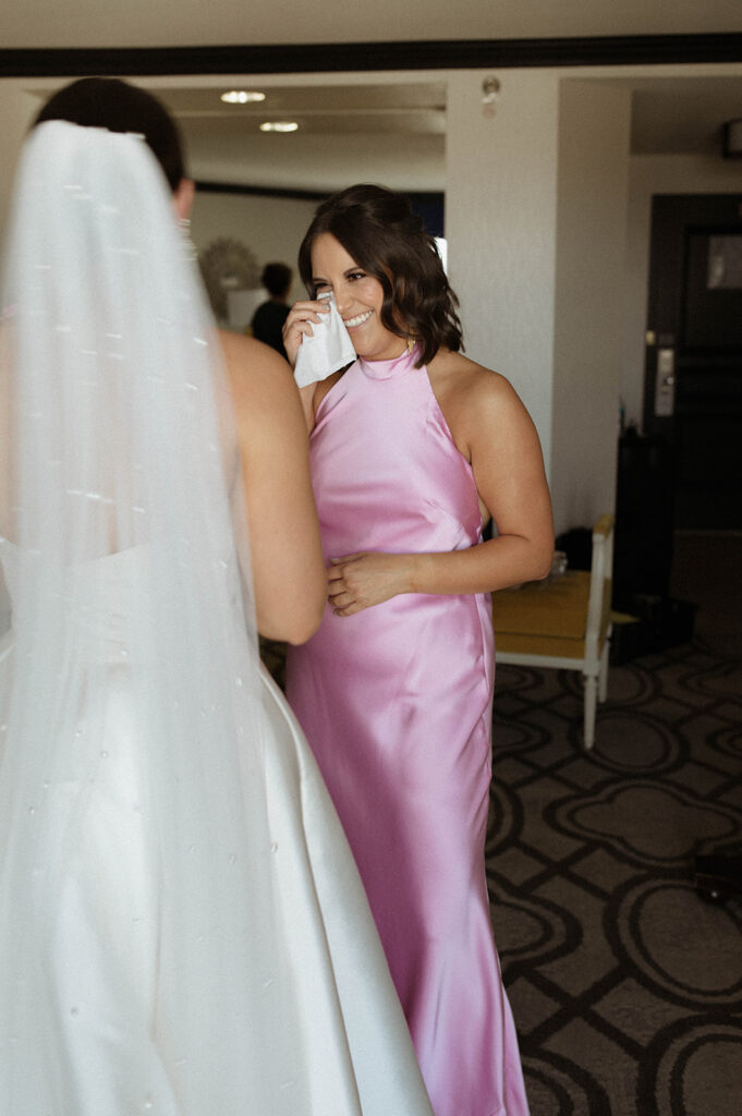 Bride doing first look with bridesmaid 