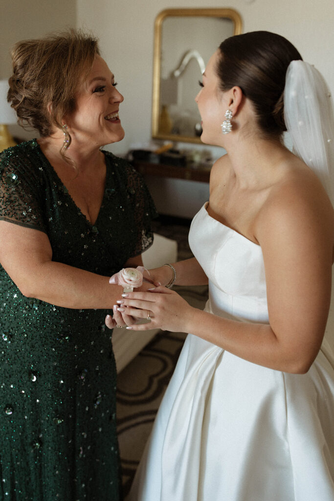 Bride giving mother corsage 