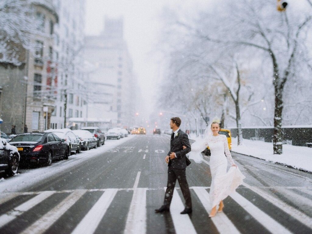 Winter's Charm: Unveiling Sparkling Winter Wedding Ideas! Couple crossing the street while its snowing 