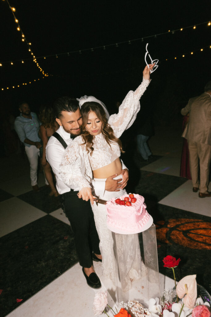 Couple cutting cake on dance floor. A Guide to Creating the Perfect Intimate Backyard Wedding