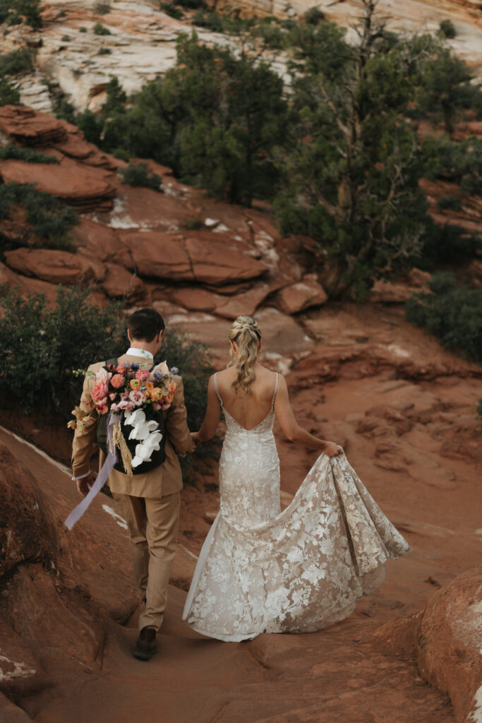 Beyond Vows: The Epic Zion National Park Wedding bride and groom hiking