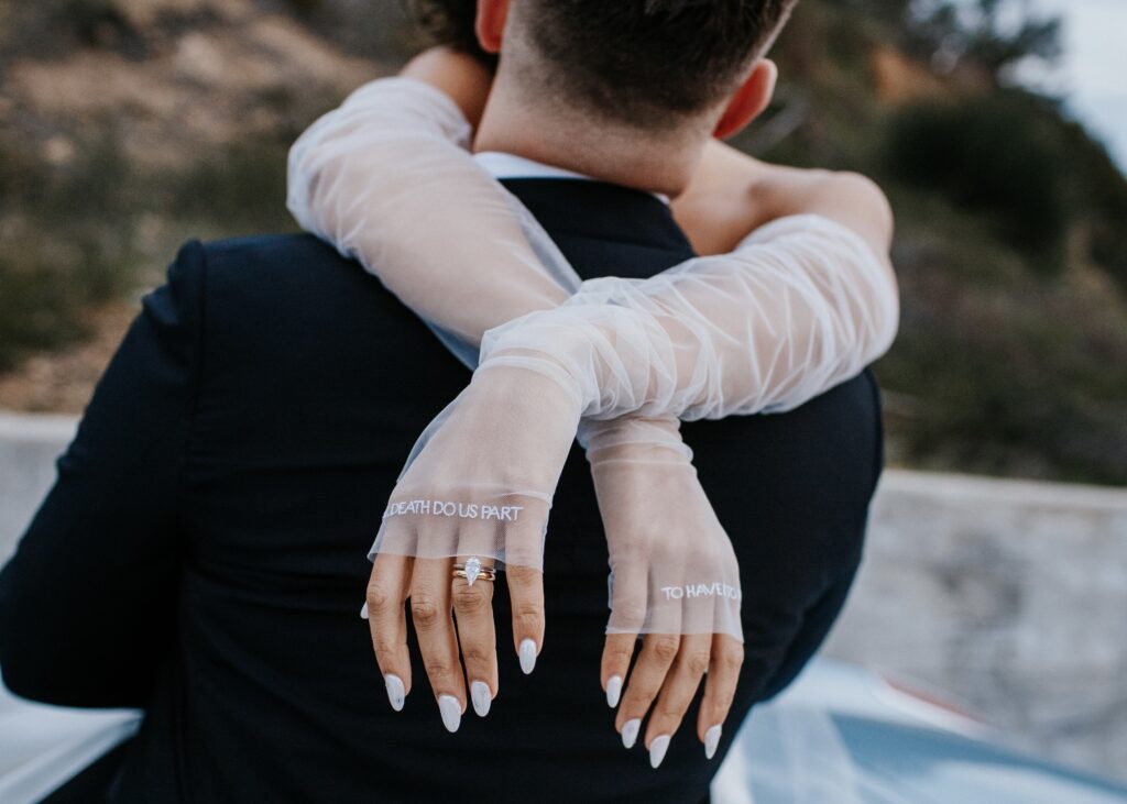 Fierce Wedding Nail Ideas. Bride hugging groom with white wedding nails 