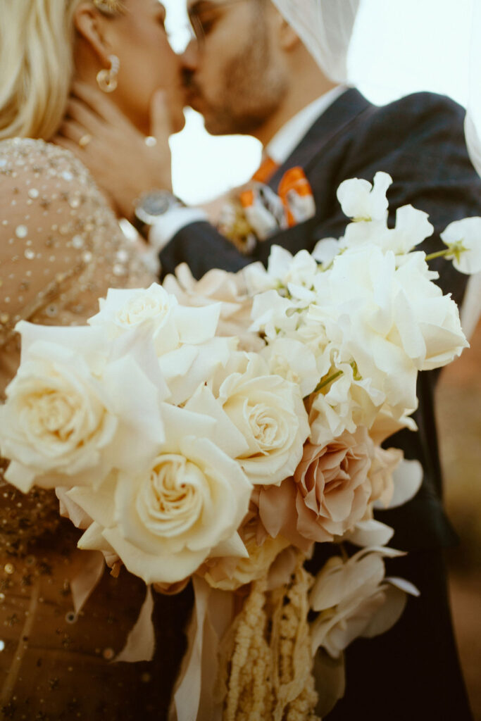 A Neutral Bouquet with the bride and groom on their wedding day