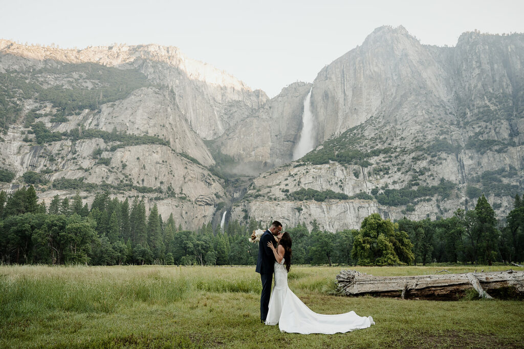 Yosemite Micro-Wedding: Why Intimate Celebrations are a Vibe. Newlyweds kissing with waterfall in the background 