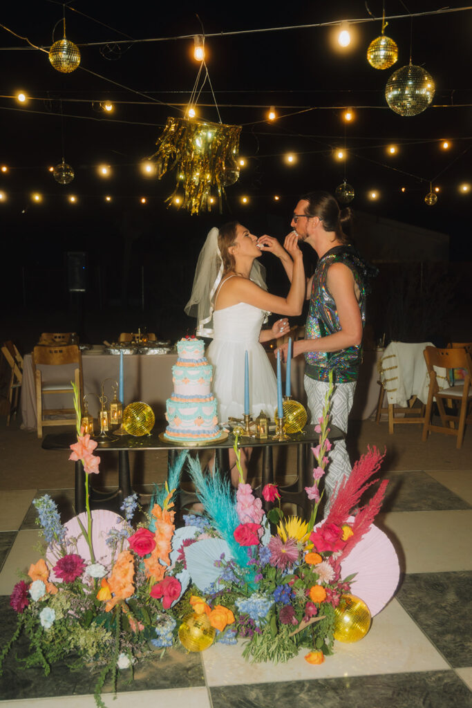 Lexi & Jacob Joshua Tree Wedding Sharing the First Bite of Cake 