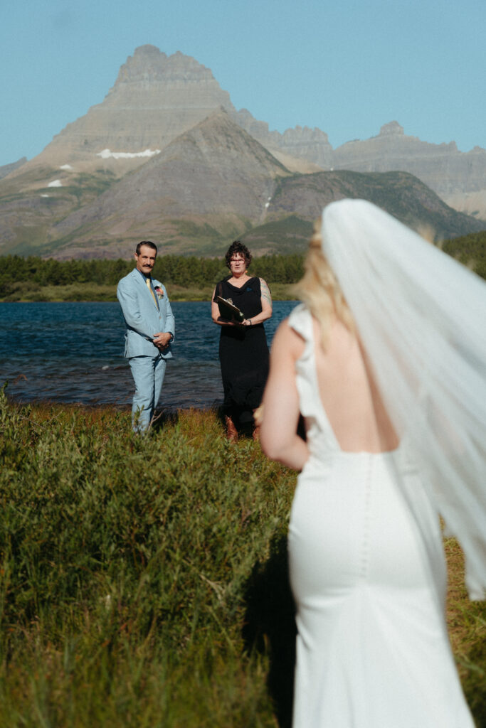 Glacier National Park Wedding, Niki Day Creative the bride walking down the aisle