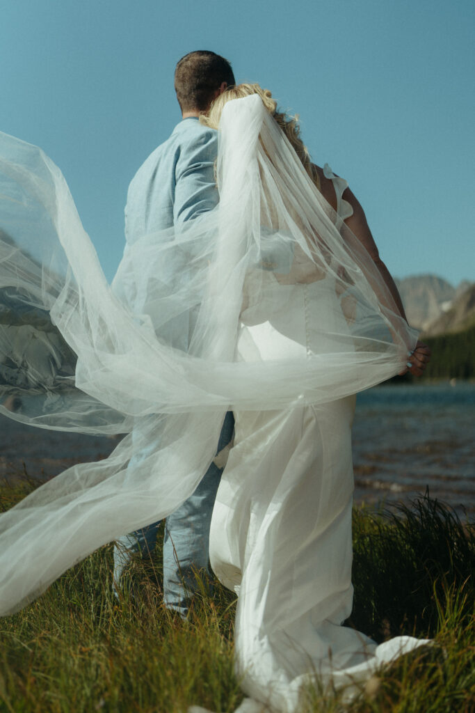 Glacier National Park Wedding, Niki Day Creative the brides veil blowing in the wind