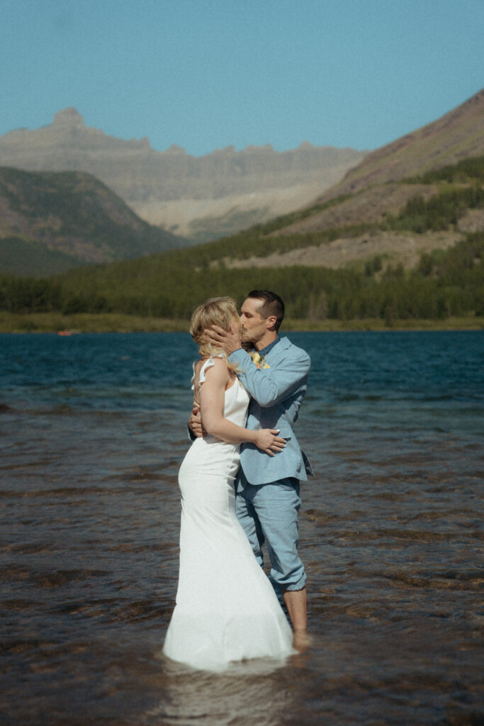 Glacier National Park Wedding, Niki Day Creative sharing a kiss