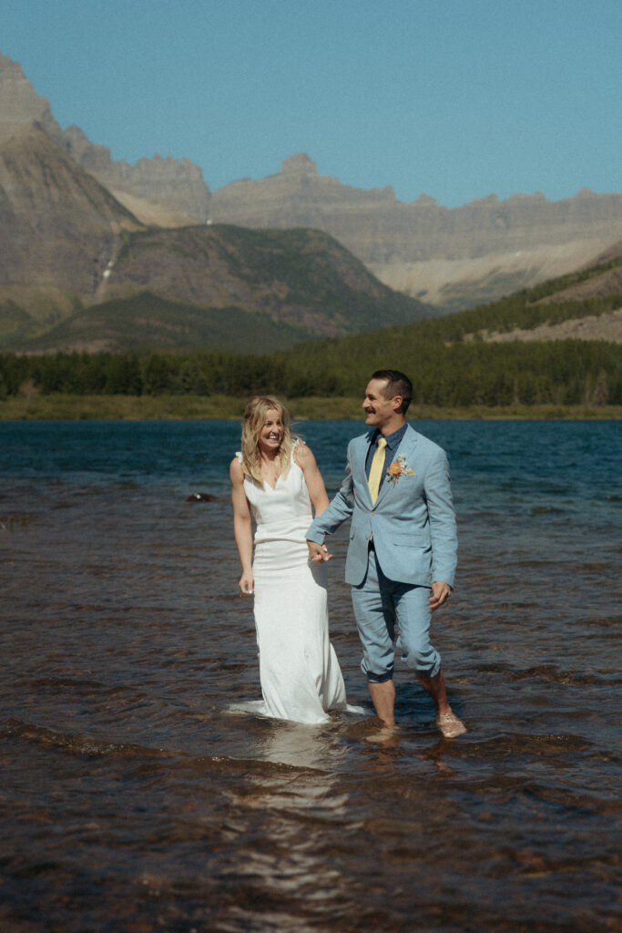 Glacier National Park Wedding, Niki Day Creative the bride and groom enjoying the time on the water