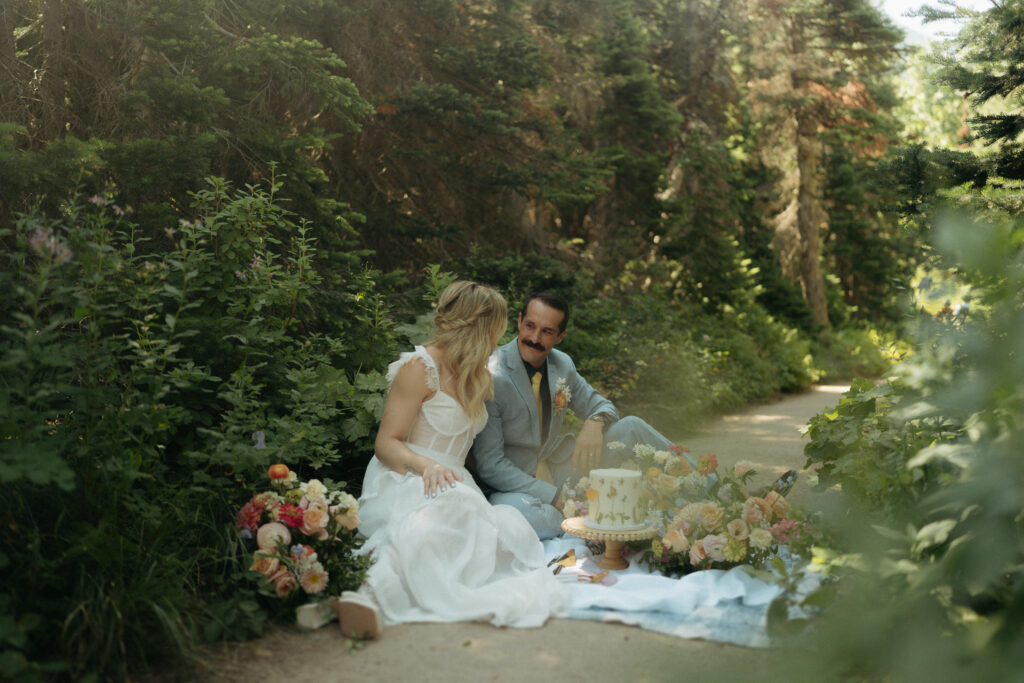 Glacier National Park Wedding, Niki Day Creative Sharing the wedding cake together