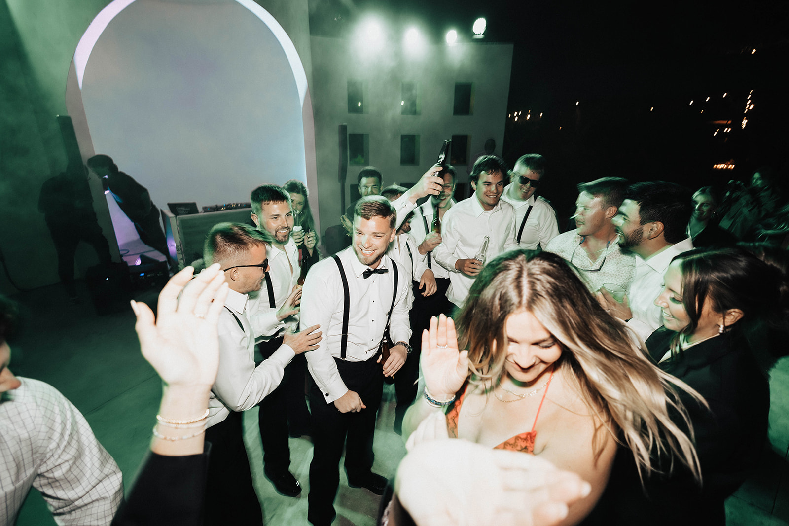 Group of people enjoying a dance party at a wedding