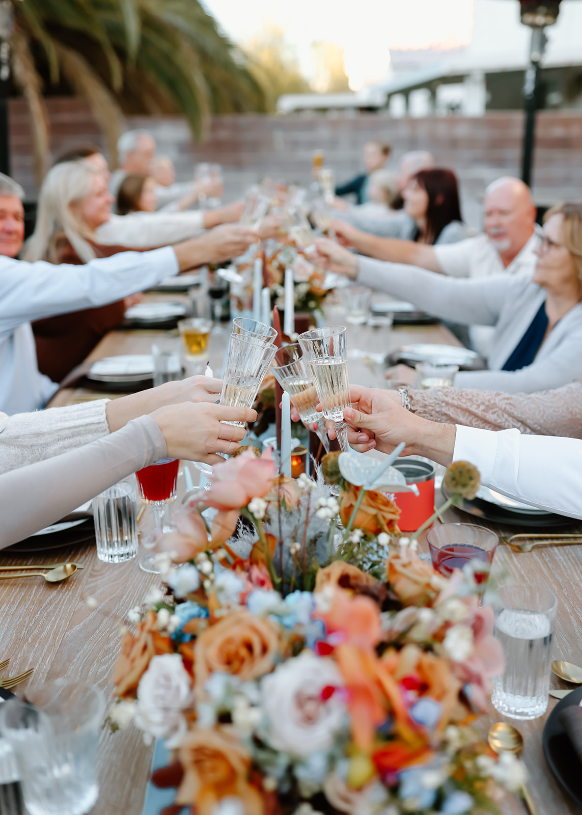 Family enjoys thanksgiving dinner together at the thanksgiving dinner table designed and styled by Ember and stone events