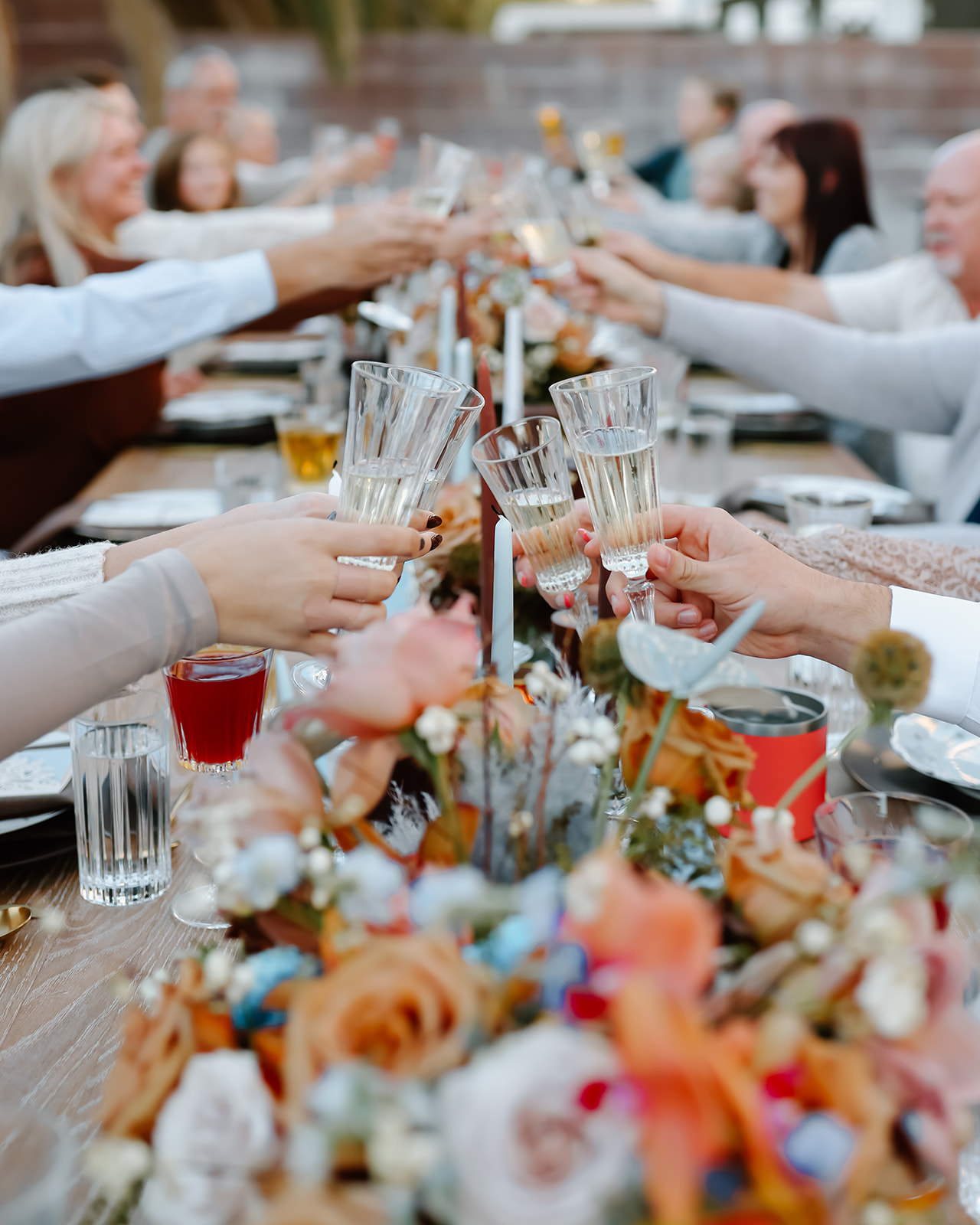 Family enjoys thanksgiving dinner together at the thanksgiving dinner table designed and styled by Ember and stone events