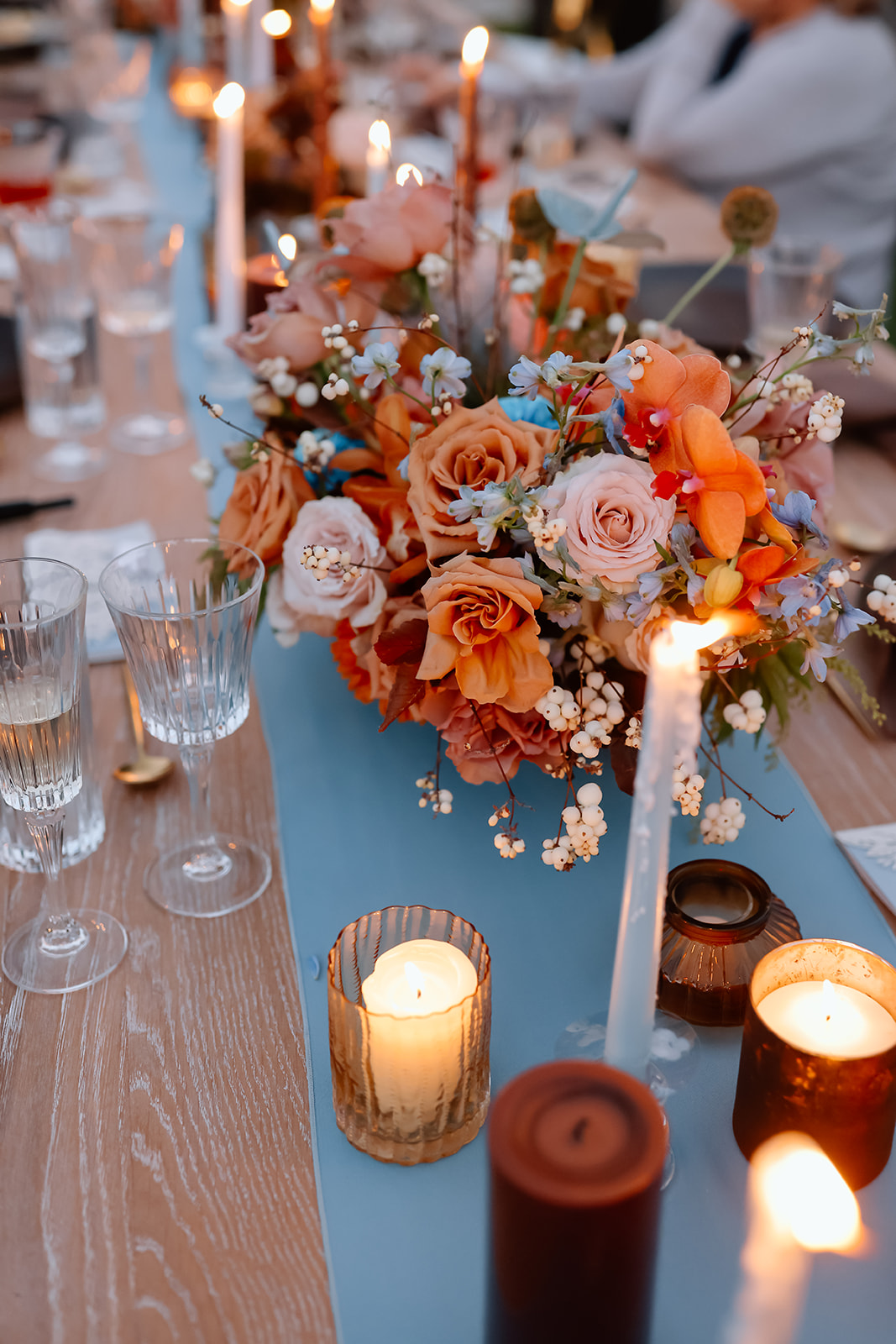 Family enjoys thanksgiving dinner together at the thanksgiving dinner table designed and styled by Ember and stone events