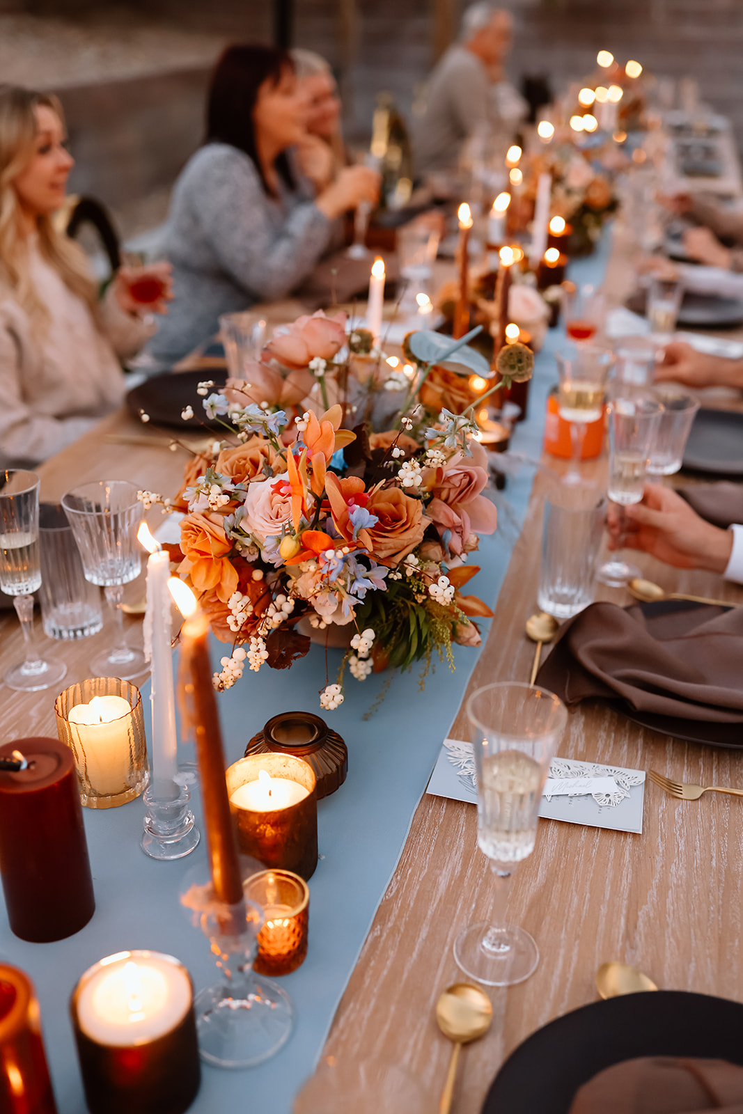 Family enjoys thanksgiving dinner together at the thanksgiving dinner table designed and styled by Ember and stone events