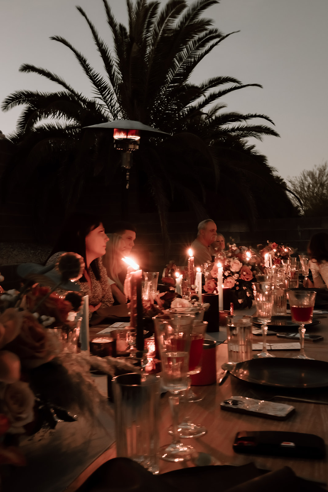 Family enjoys thanksgiving dinner together at the thanksgiving dinner table designed and styled by Ember and stone events