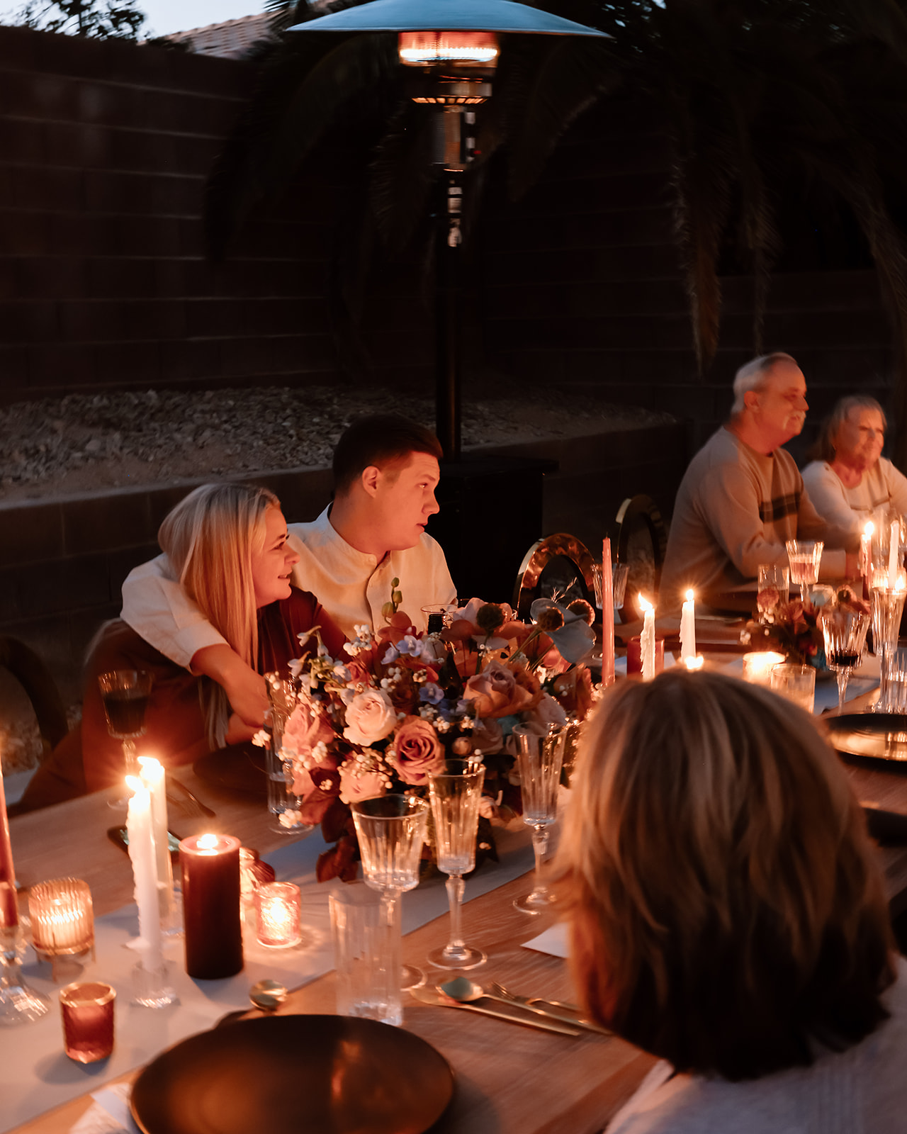 Family enjoys thanksgiving dinner together at the thanksgiving dinner table designed and styled by Ember and stone events