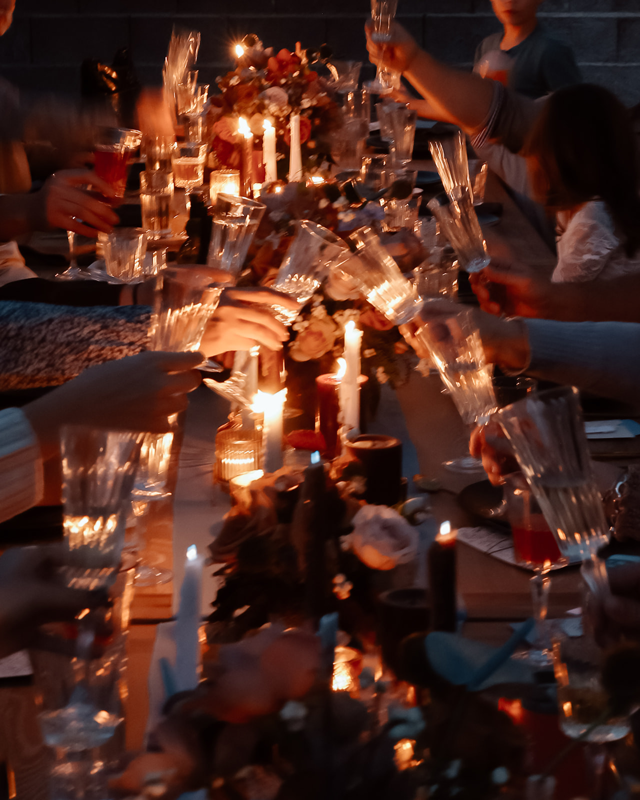 Family enjoys thanksgiving dinner together at the thanksgiving dinner table designed and styled by Ember and stone events