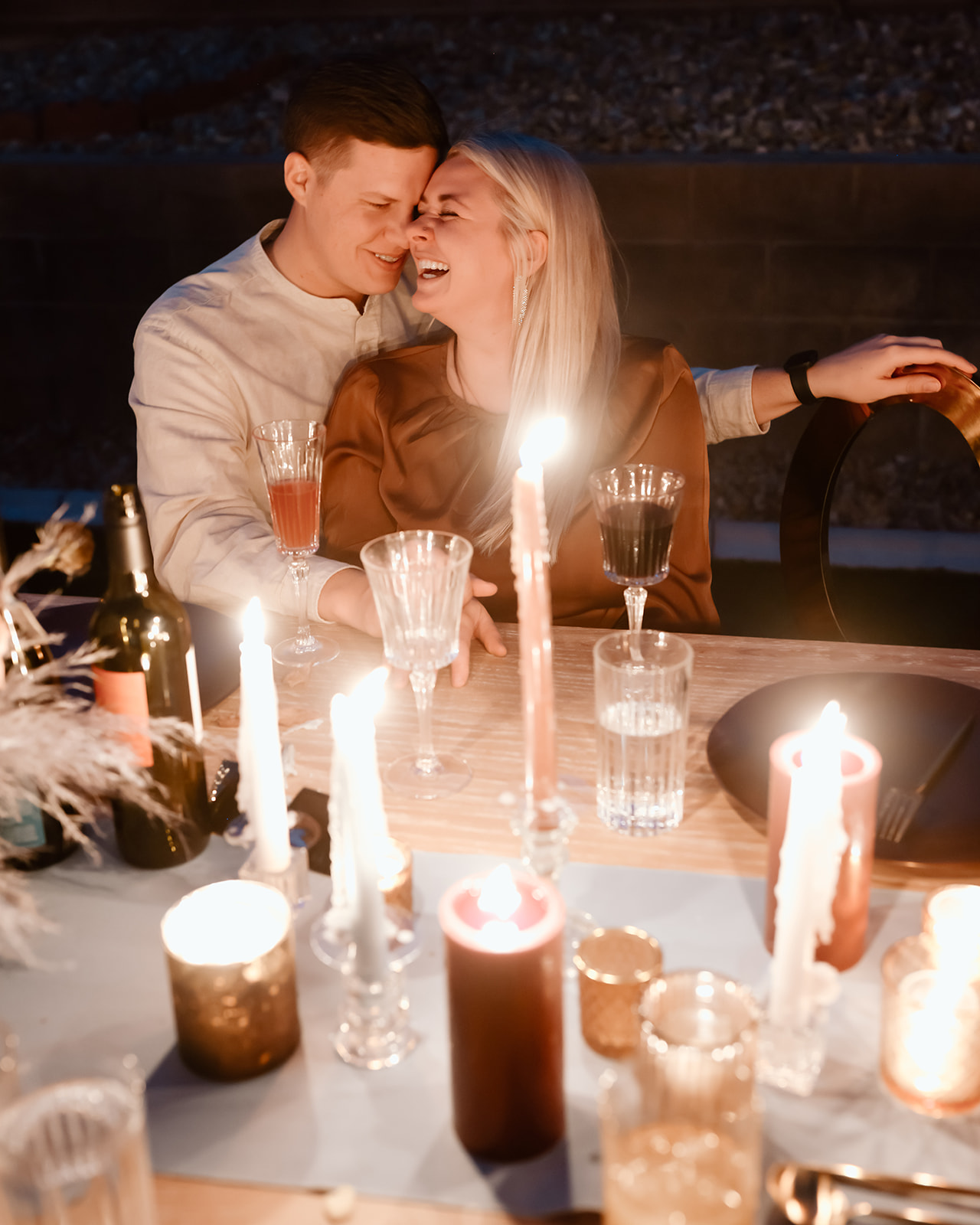 Family enjoys thanksgiving dinner together at the thanksgiving dinner table designed and styled by Ember and stone events