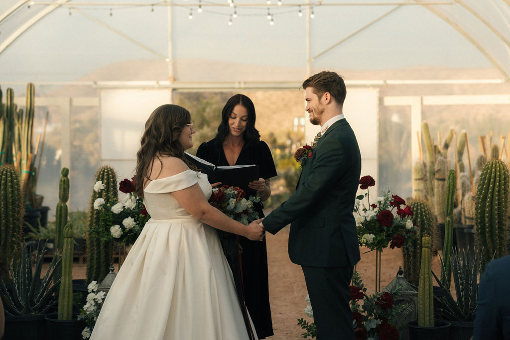 Bride and groom holding hands during their wedding ceremony at Cactus Joe's