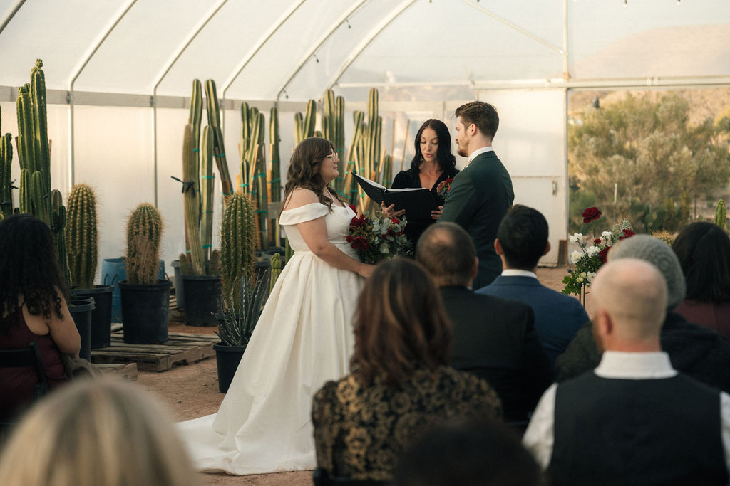 Bride and groom holding hands during their wedding ceremony at Cactus Joe's