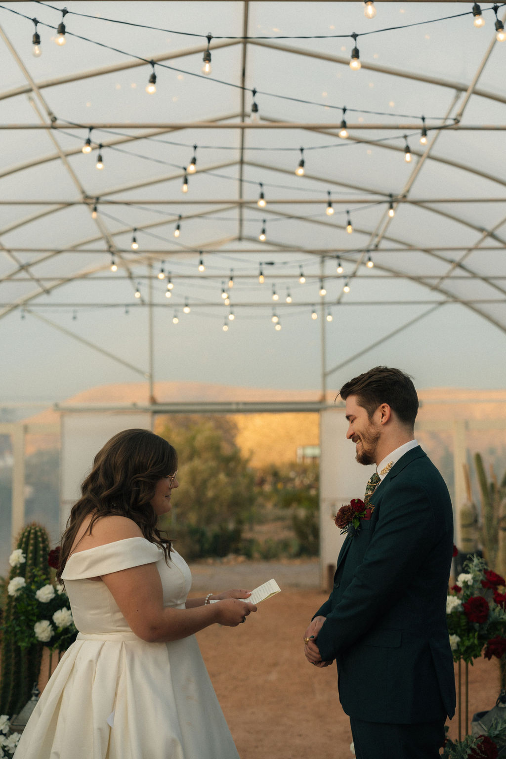 Bride and groom holding hands during their wedding ceremony at Cactus Joe's