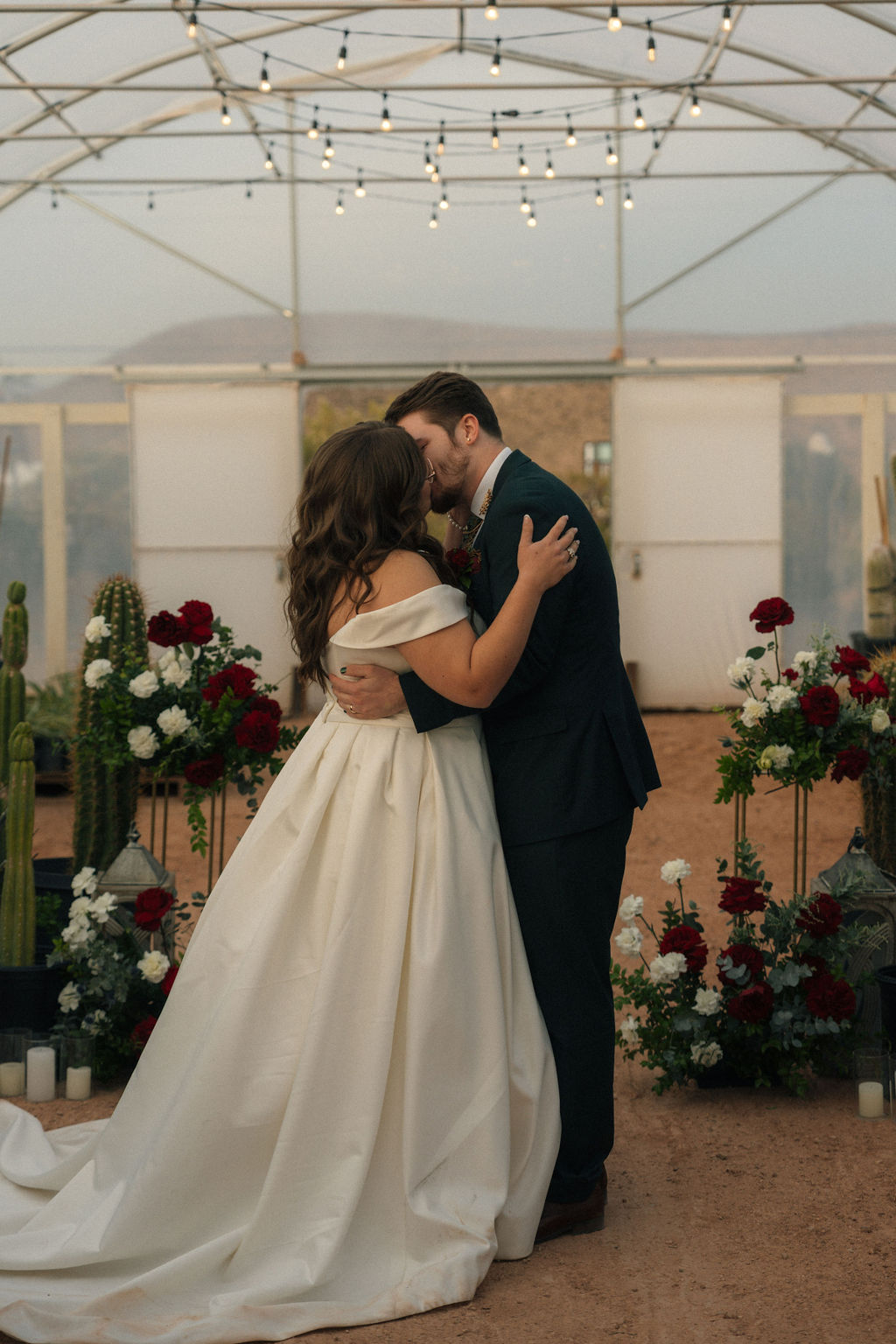 Bride and groom kissing during their wedding ceremony at Cactus Joe's