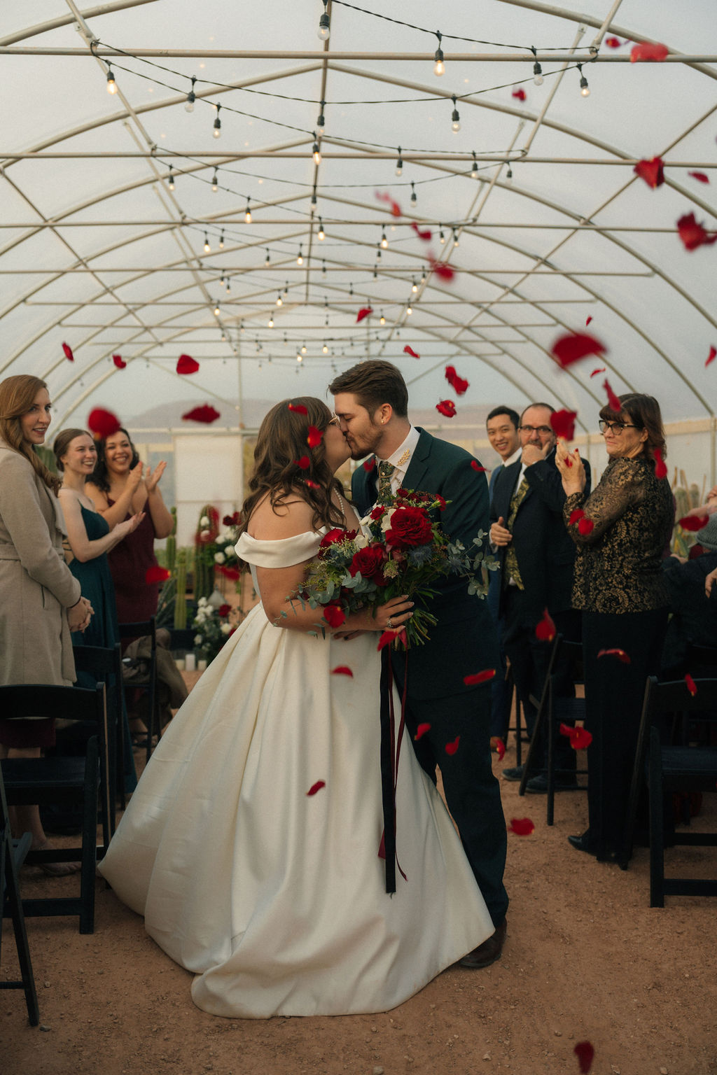 Couple exiting their wedding ceremony as petals are being thrown at Cactus Joe's Nursery