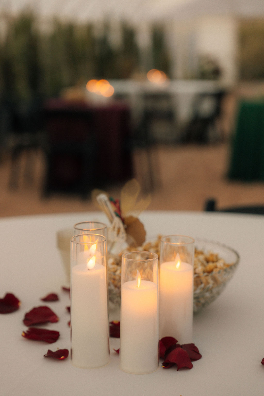 Table setting at a wedding with candles and petals