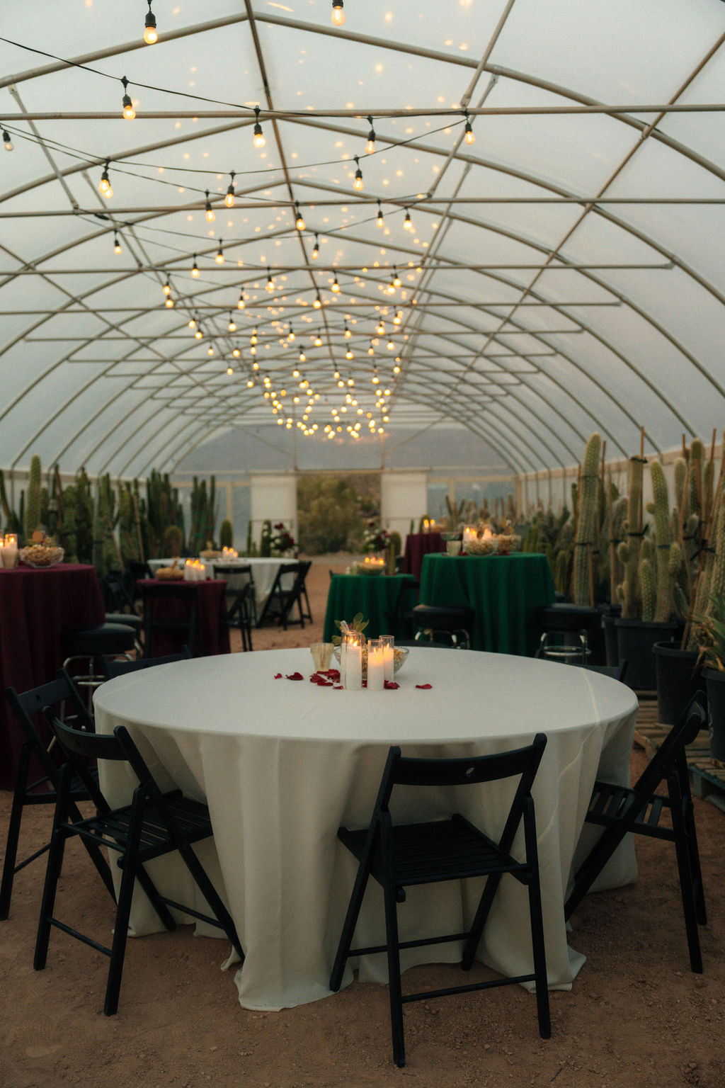 Table setting at a wedding with candles and petals