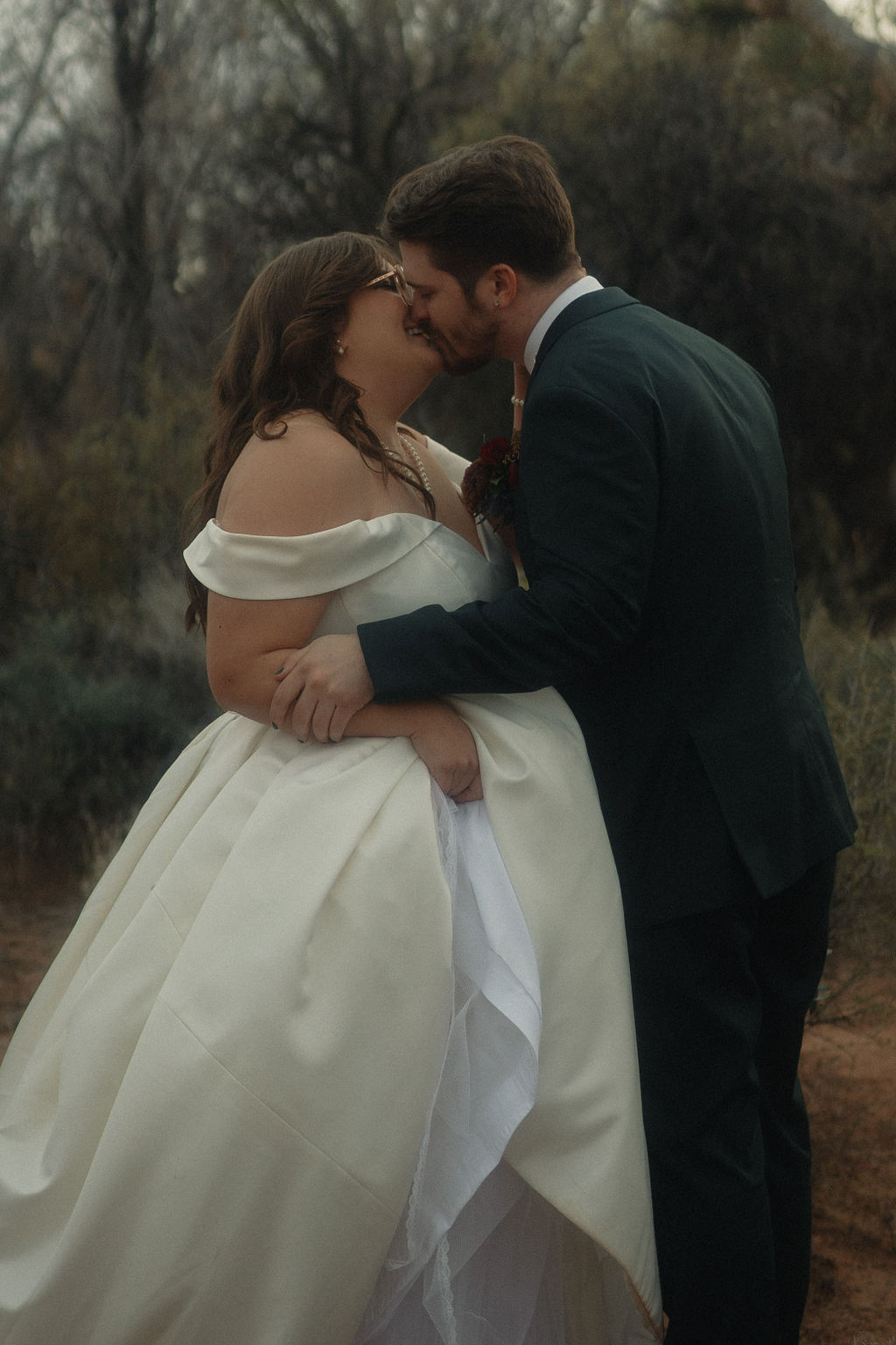 Couple posing on their wedding day at Cactus Joe's Nursery 