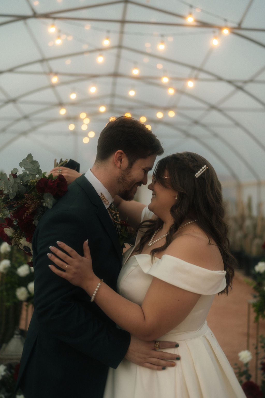 couple holding eachother and about to kiss during their wedding reception