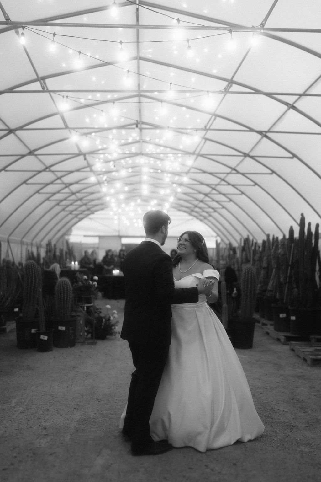 Couple dancing during their first dance surrounded by cacti 