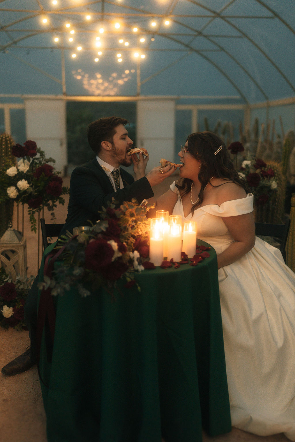 Couple enjoying their wedding and eating pizza during their reception 