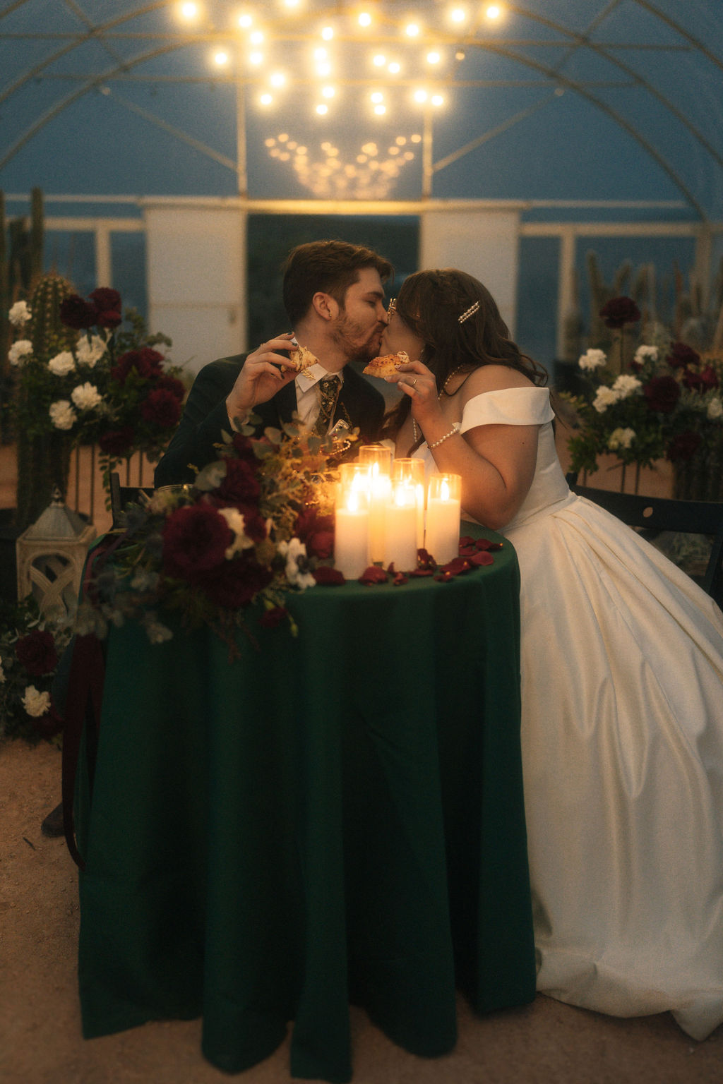 Couple enjoying their wedding and eating pizza during their reception 